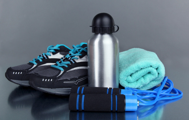 Different tools for sport on grey background - Foto, Imagen