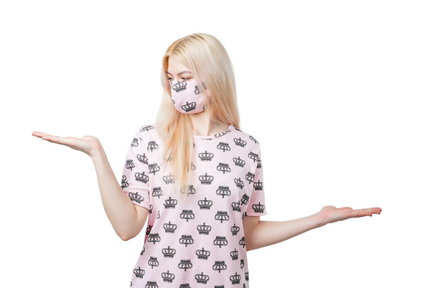 Young blonde girl in the pink mask and blouse shows gesture - Photo, Image