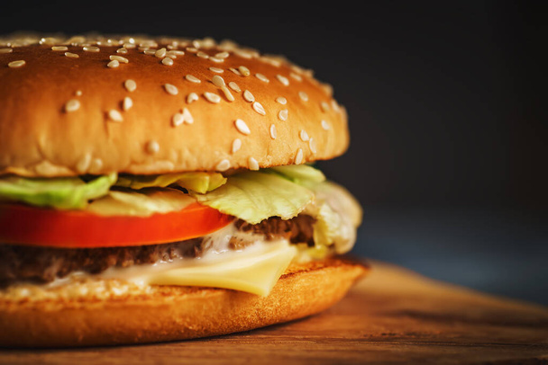Fresh homemade burger or hamburger, fast food, macro photo, copy space - Fotó, kép