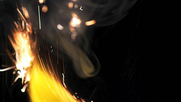 Macro photo of Bonfire sparks. Fire Flames bursts, blasts. Explosion micro sparkles. Mini Fireworks. Shooting on Red camera still on black background. Beautiful leaks overlay spark poster, banner, wallpaper, backdrop, texture. - 写真・画像