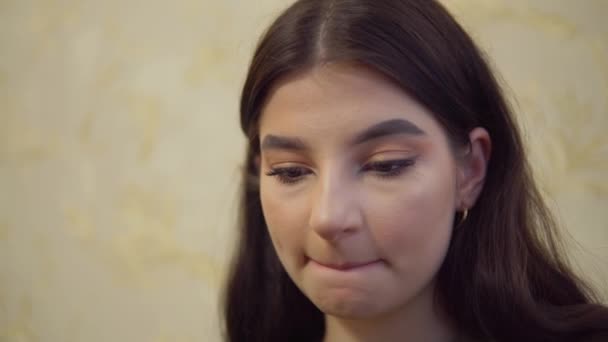 artist girl tucks hair behind the ear, dirty hand in coal, draws painter - Footage, Video