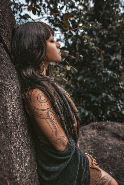 beautiful young stylish tribal style woman outdoors portrait - 写真・画像