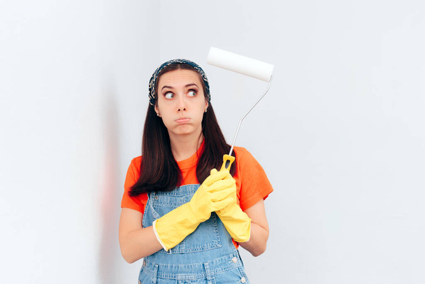 Stressed Woman Painting the Wall at Home with White Paint - Fotoğraf, Görsel