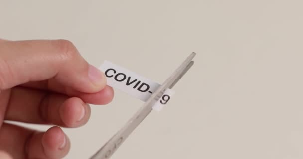 concept of destroying corona virus. A pair of scissor scissors called the virus is printed on paper - Footage, Video
