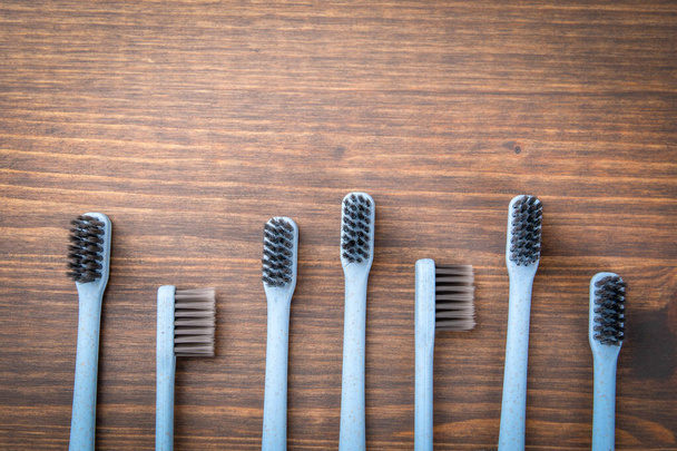 Toothbrushes, copy space on a wooden background. Dental hygiene - Φωτογραφία, εικόνα