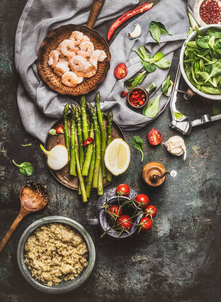 Tasty quinoa salad preparation with wooden spoon , Shrimps , asparagus and various healthy vegetables on rustic  kitchen table background, top view - Fotografie, Obrázek