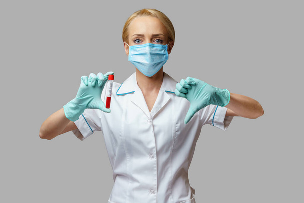 medical doctor nurse woman wearing protective mask and gloves - holding virus blood test - Photo, Image
