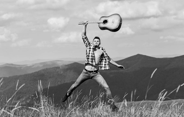hard rock. western camping and hiking. happy and free. cowboy man with bare muscular torso. acoustic guitar player. country music song. sexy man with guitar in checkered shirt. hipster fashion - Fotografie, Obrázek