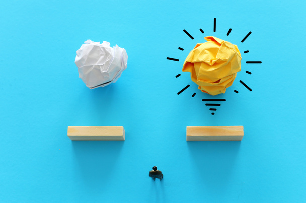 Education concept image. Creative idea and innovation. Crumpled paper as light bulb metaphor over blue background - Foto, Imagem