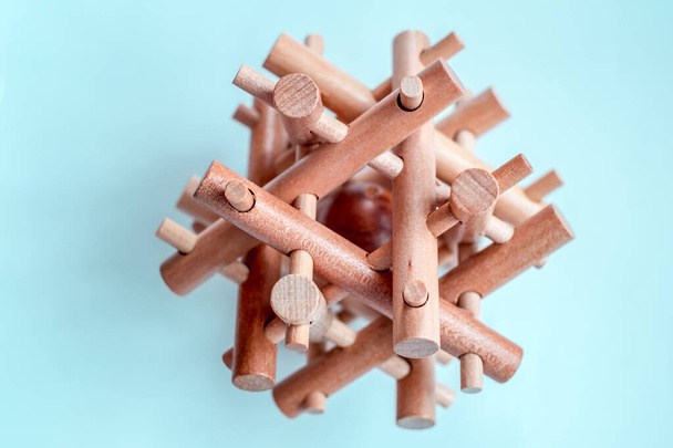 Wooden Brain Bamboo Puzzle on blue background - 写真・画像
