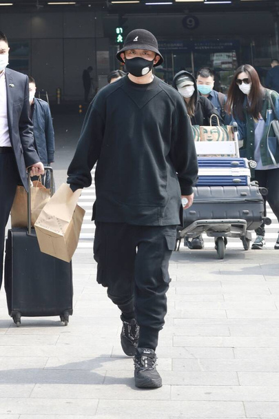 Chinese rapper, singer, and songwriter Zhou Yan, known as "GAI" arrives in an airport in Beijing, China, April 14, 2020. - Zdjęcie, obraz