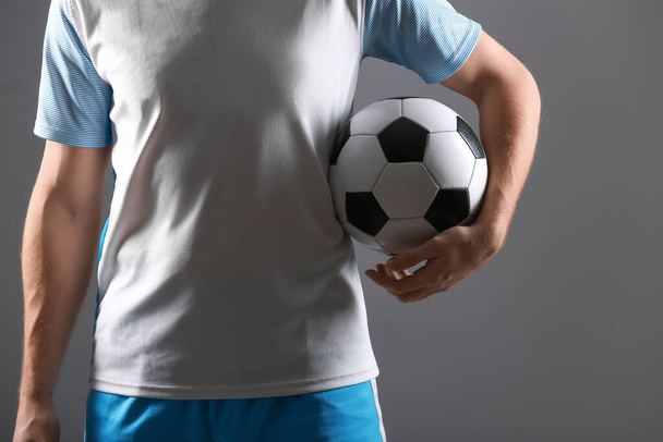 Silhouette of male football player on dark background - Valokuva, kuva