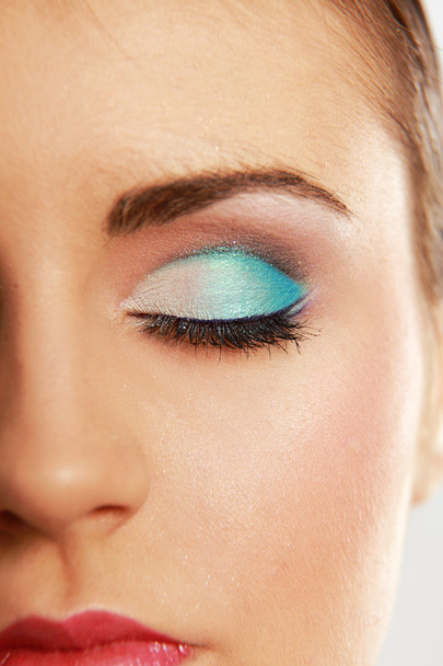 Woman eye with exotic style makeup - Foto, afbeelding