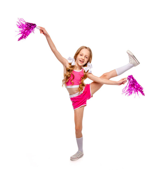 girl in pink cheerleader clothes dancing with shiny pompons in her hands - Photo, Image