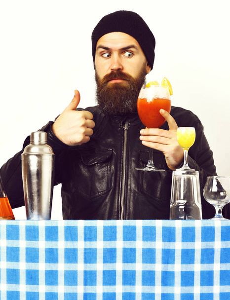 Brutal caucasian hipster holding alcoholic beverage or fresh cocktail - Фото, изображение