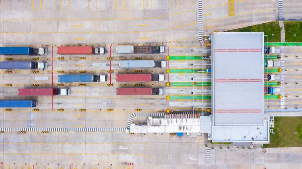 Vue aérienne grands camions porte-conteneurs entrant avec conteneur de marchandises par la porte d'entrée principale dans le port industriel
. - Photo, image