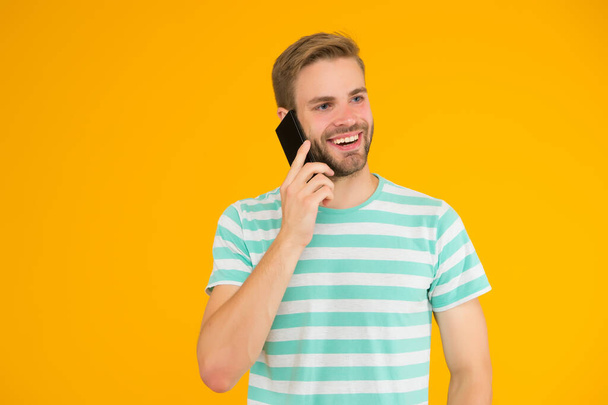 Importance of being communicative. Happy man talk on mobile phone yellow background. Verbal communication. Mobile communication. Telephone communication. Communication technology. Modern life - Foto, Imagen