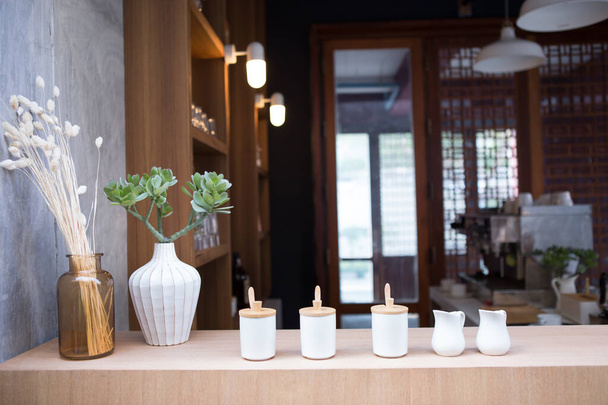 on the coffee counter bar have many ceramic mugs for milk, sugar and some ingredients - 写真・画像