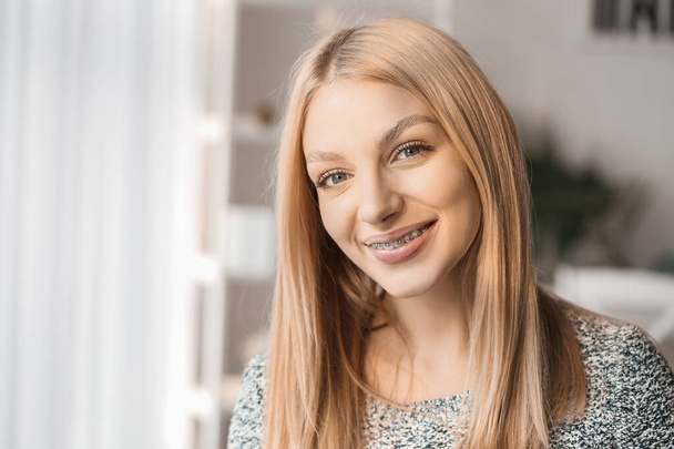 Young woman with dental braces at home - Photo, Image