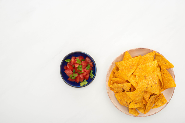 top view of corn nachos with chili on white background - 写真・画像