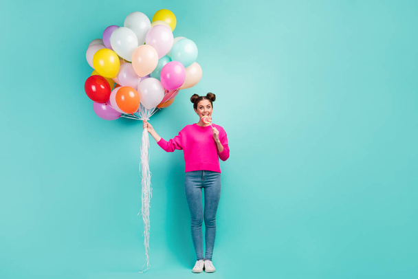 Full length body size view of her she nice attractive cheerful wavy-haired girl holding in hand air balls biting lolli-pop festal day isolated on bright vivid shine vibrant green blue color background - Foto, immagini