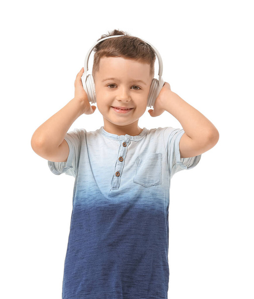 Cute little boy listening to music on white background - Photo, Image