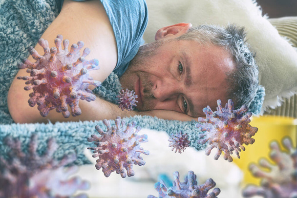 Człowiek cierpiący na chorobę wirusową leży smutno pokryty kocem na łóżku. koncepcja zakażenia koronawirusem - Zdjęcie, obraz
