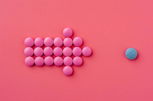 Close-up of pink pills lie on a pink surface - Foto, Imagen