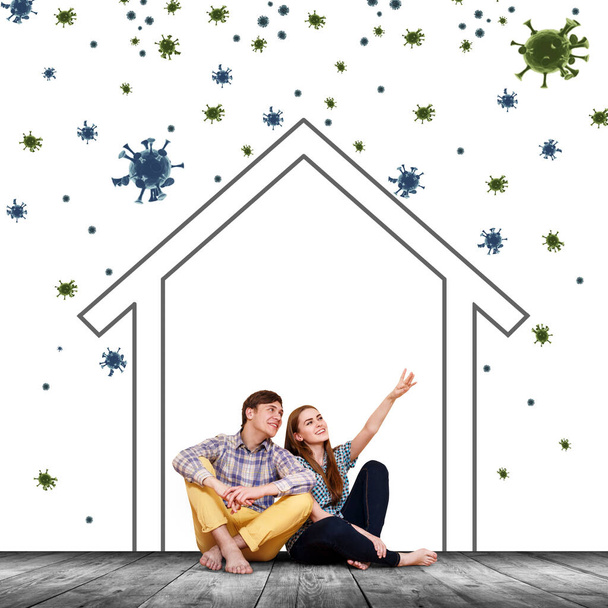 Пара сидящих на полу с краской дома среди коронавирусных клеток
. - Фото, изображение