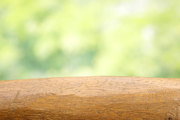 Empty wooden table on outdoor bokeh background. Summer time. Table for product design. - Photo, Image