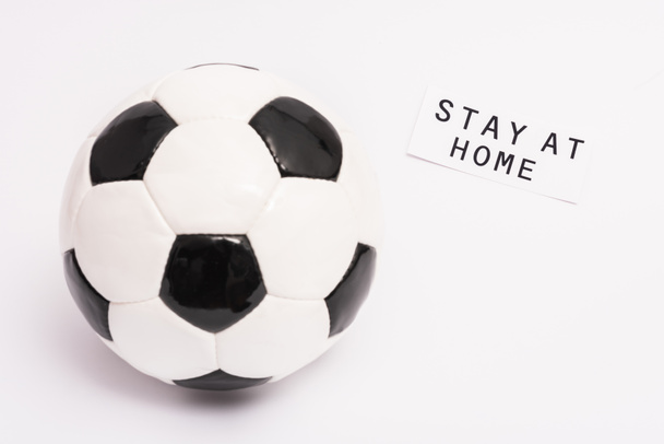 football near paper with stay at home lettering on white with copy space - Fotografie, Obrázek