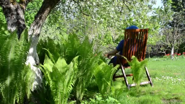 Tired gardener sit chair - Footage, Video