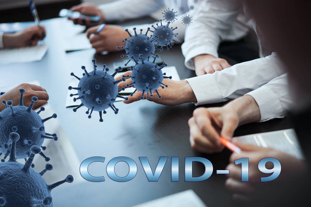 A group of business people sitting in the office at the table from which the flies fly out. The concept of work at home, distance work, training in connection with the COVID-19 epidemic. - Foto, Bild