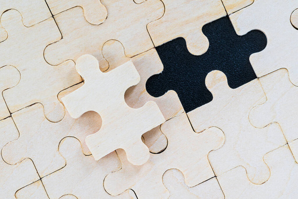 Shot of wooden jigsaw puzzle pieces on black background,Business concept - Photo, Image