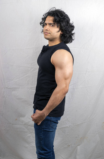 young indian model wearing black tshirt side pose - Foto, Bild