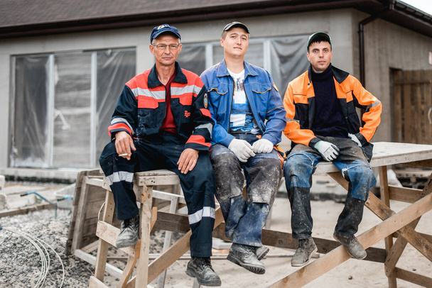 business, building, teamwork and people concept - group of smiling builders outdoors - Photo, Image