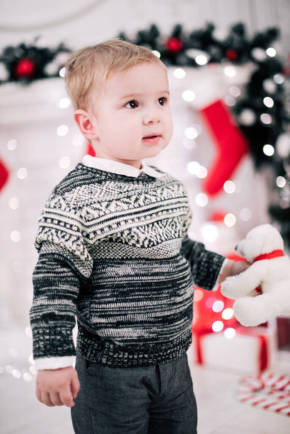 Retrato de Natal de um menino atmosfera acolhedora em torno da lareira e árvore de Natal
 - Foto, Imagem