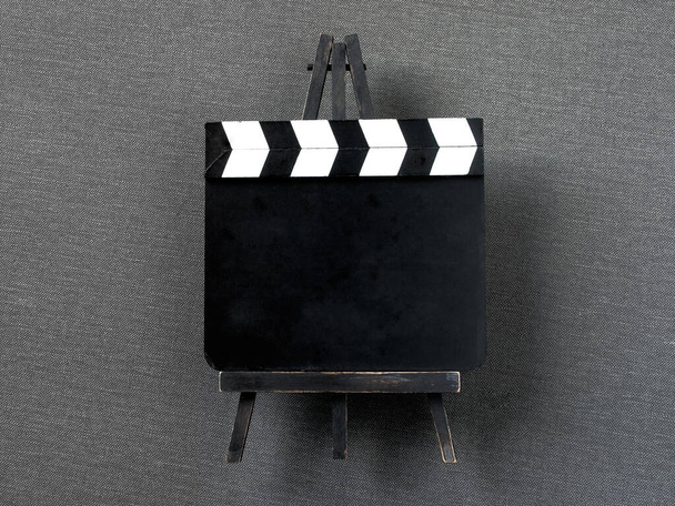 Old black and white clapperboard shot on a wooden stand. Filming equipment. - Photo, Image