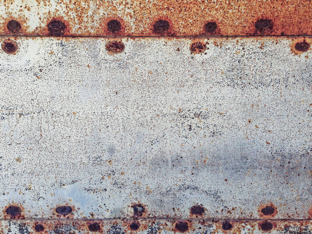 The texture of the old rusty metal sheet with rivets shot closeup - Photo, Image