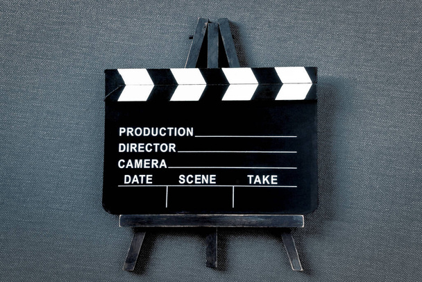 Old clapperboard shot on a wooden stand. Filming equipment. - Photo, Image