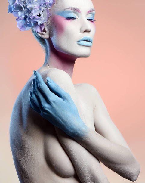 Beautiful naked girl with Blue Flowers and art make-up. Fairy beauty young woman in paint. Body art - Fotó, kép