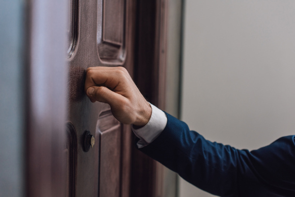 Cropped view of collector knocking on door with hand - Fotografie, Obrázek