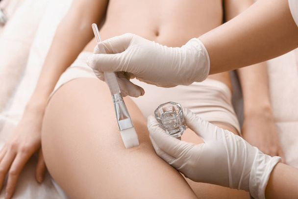 Beautiful woman undergoing procedure of anti-cellulite massage in beauty salon, closeup - Photo, Image