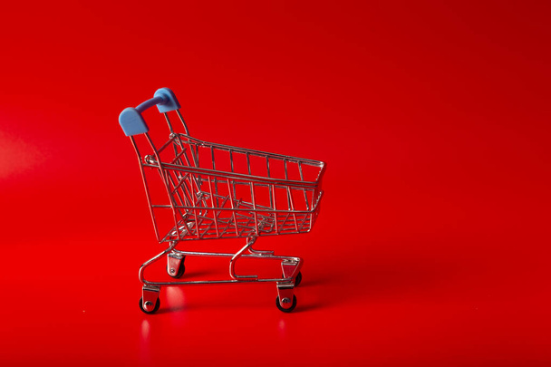 Empty Groceries trolley on red background - Photo, Image