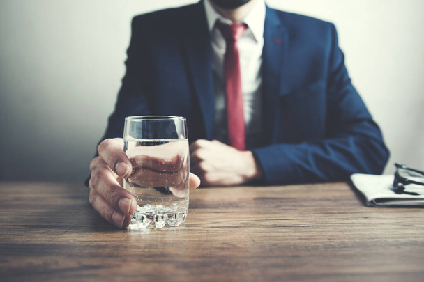 man hand glass of water on table - 写真・画像