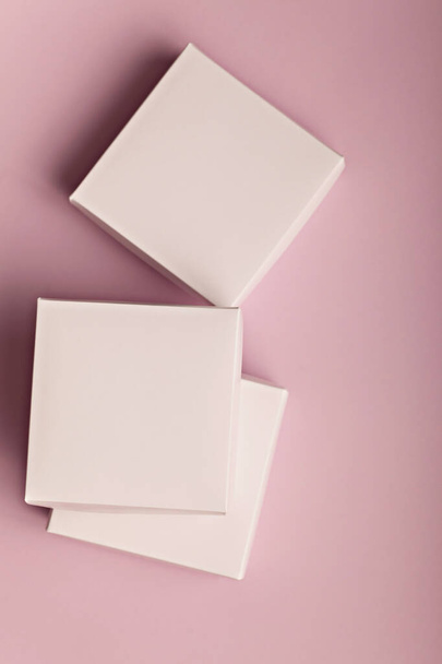 Stack of white cardboard boxes on a pink background with copyspace for your text - 写真・画像