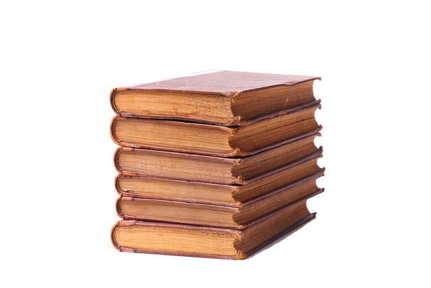 Stack of nine antique books, isolated white background. - Фото, изображение