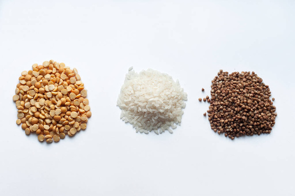 donation of food, rice, peas and buckwheat on a white background-delivery of coronavirus food - Fotografie, Obrázek