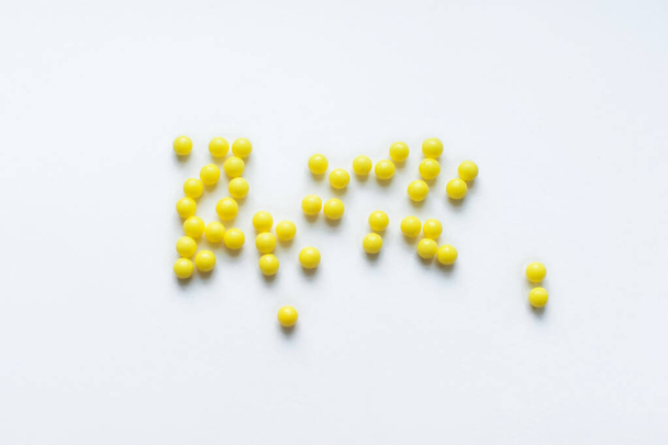 vitamins round shape yellow on a white background a cure for the virus - Valokuva, kuva
