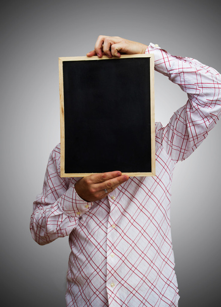 Young businessman holding blank board - Foto, imagen